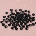 Black glass hotfix rhinestones on dreamy pink gradient background